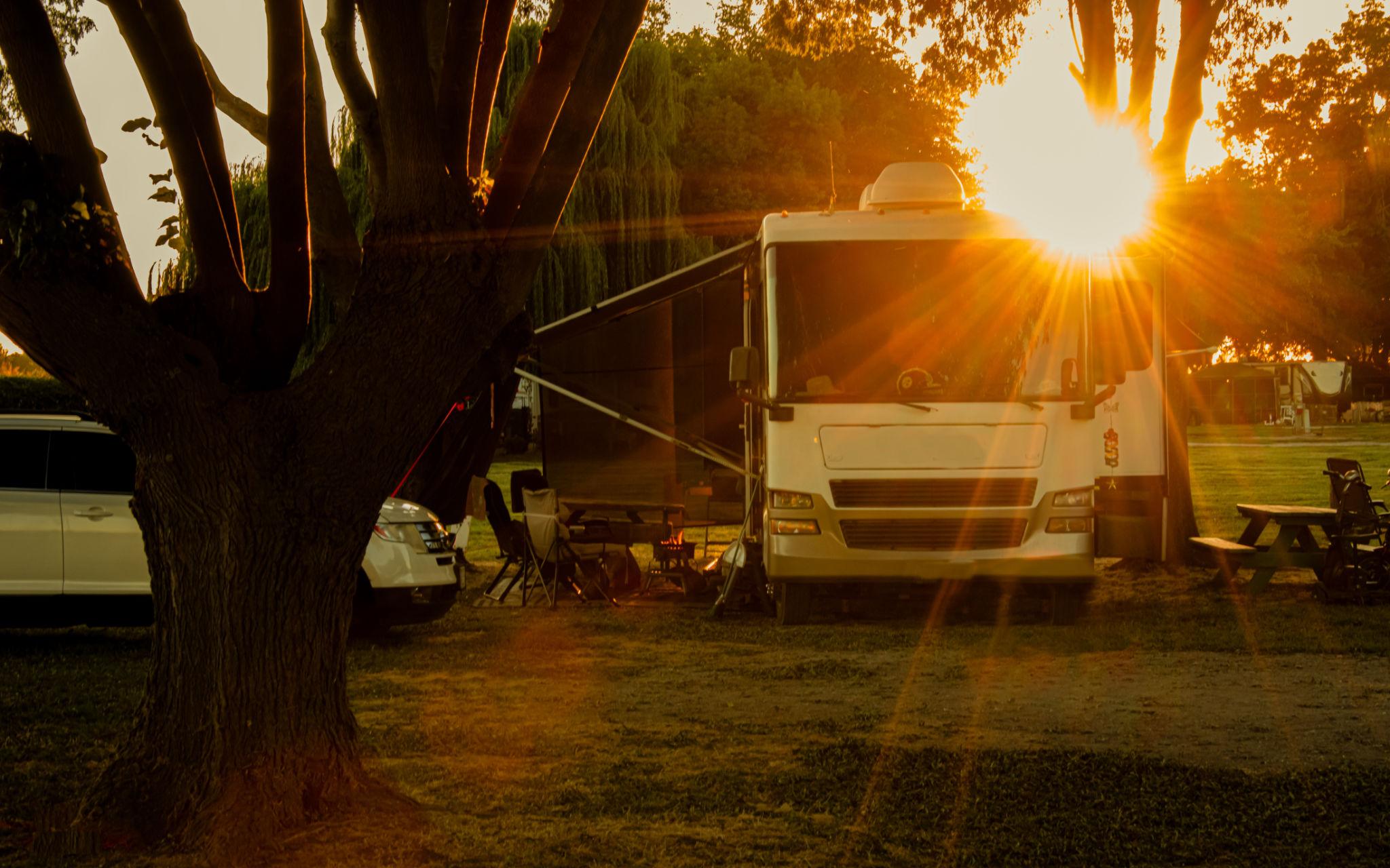 RV arriving at campsite after sunset