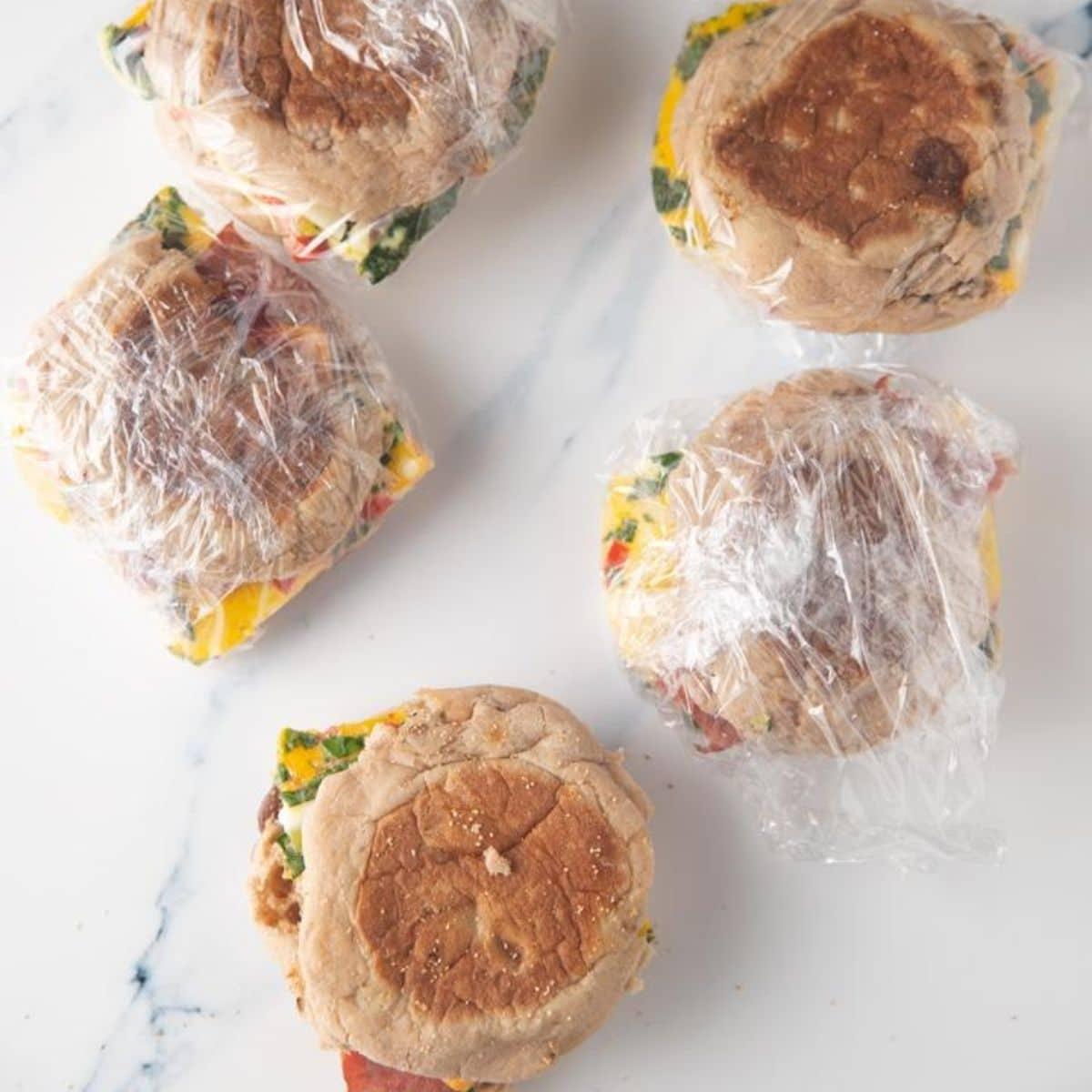 Wrapped breakfast sandwiches near campfire