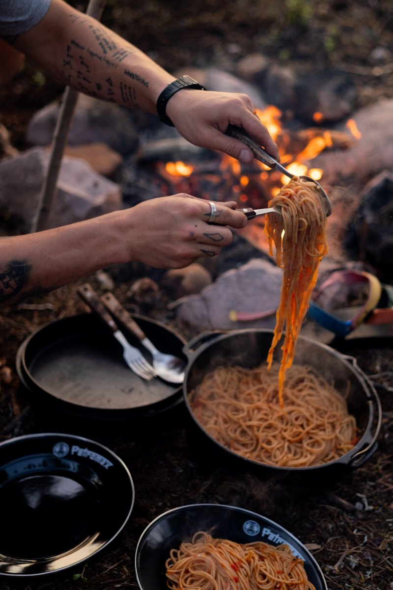 Spaghetti with meat sauce by campfire
