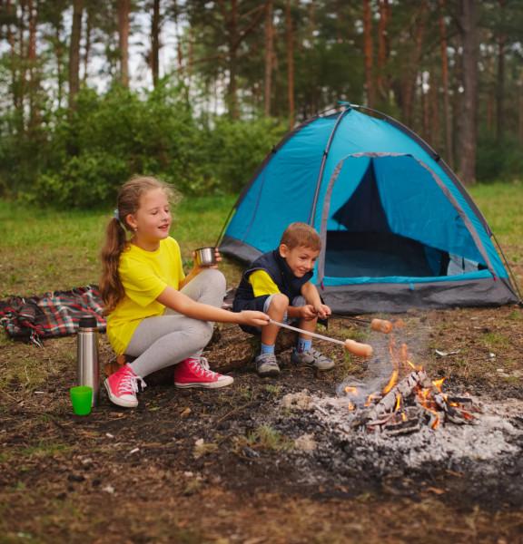 Kids roasting hot dogs camping
