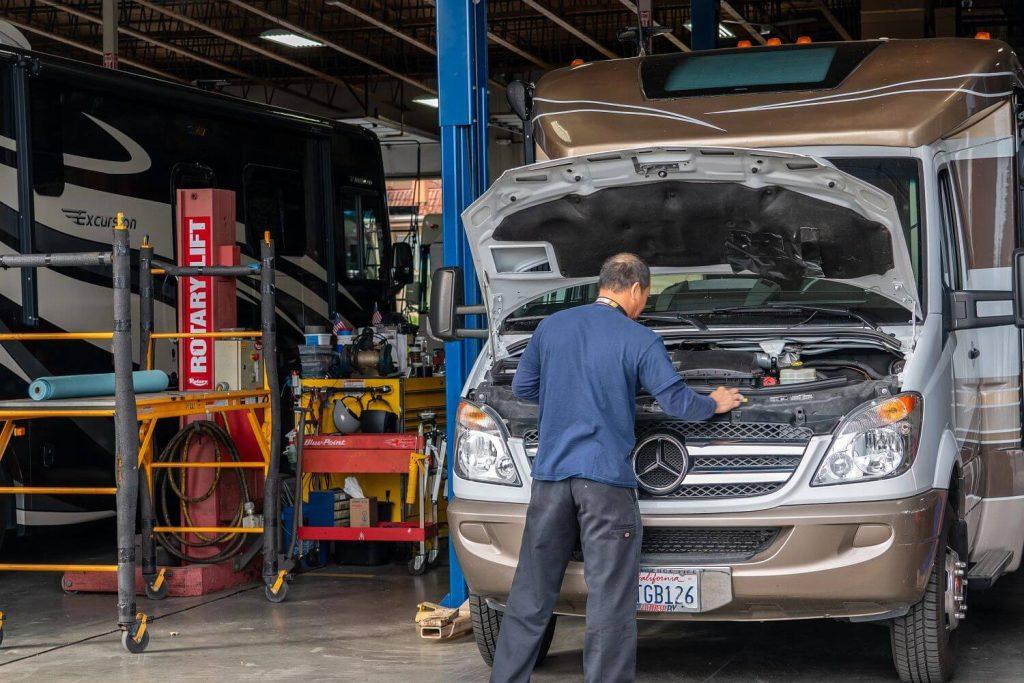 Technician performing maintenance on an RV