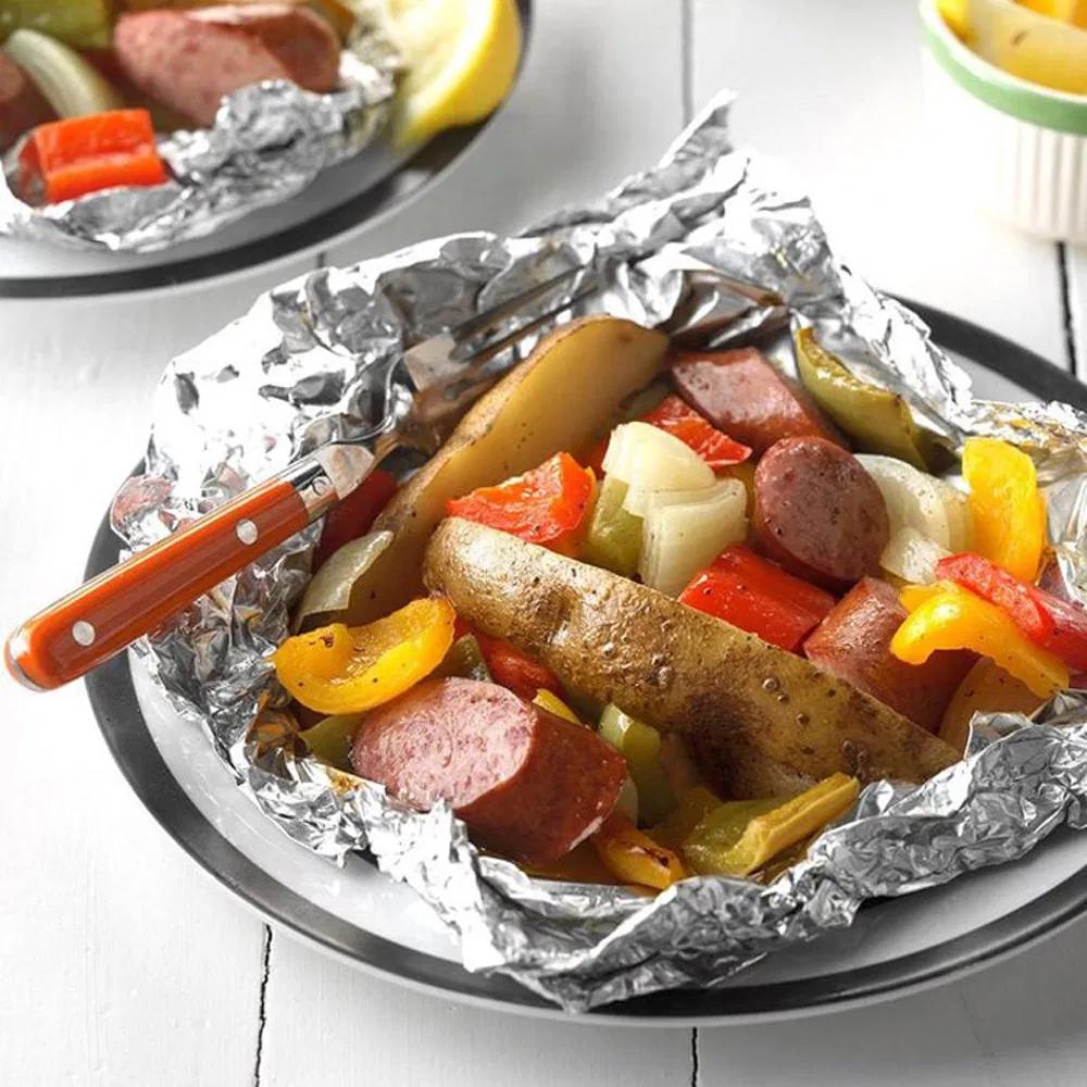 Sausage vegetable foil packet meal outdoors