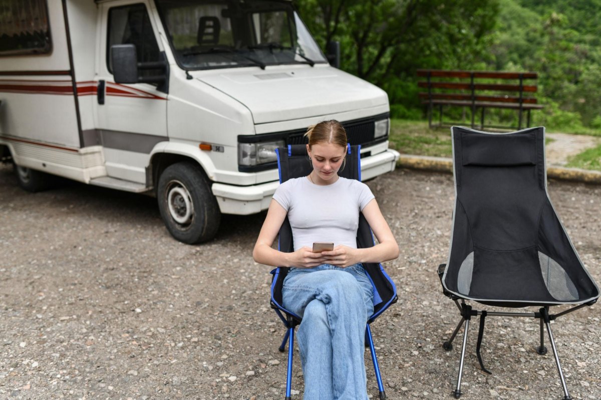 Traveler using phone at campsite